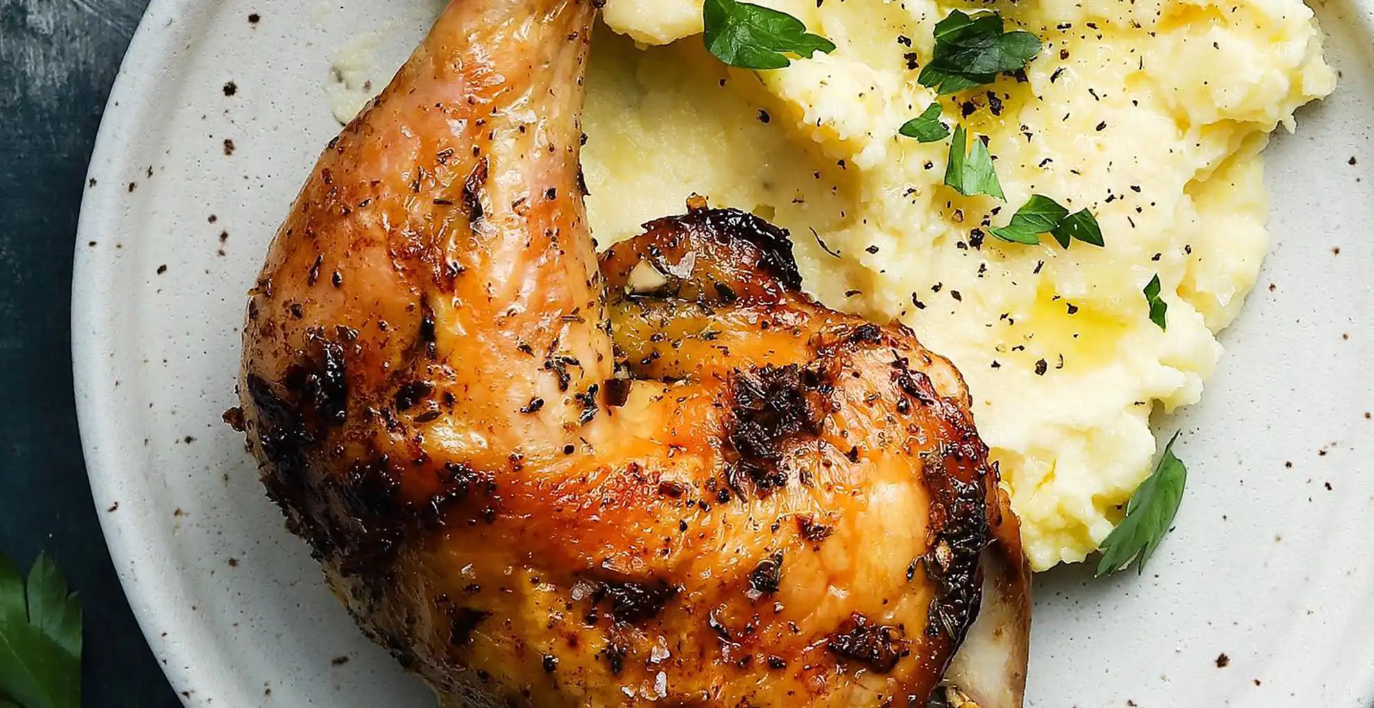 garlic herb roasted chicken on plate with pinot noir bottle