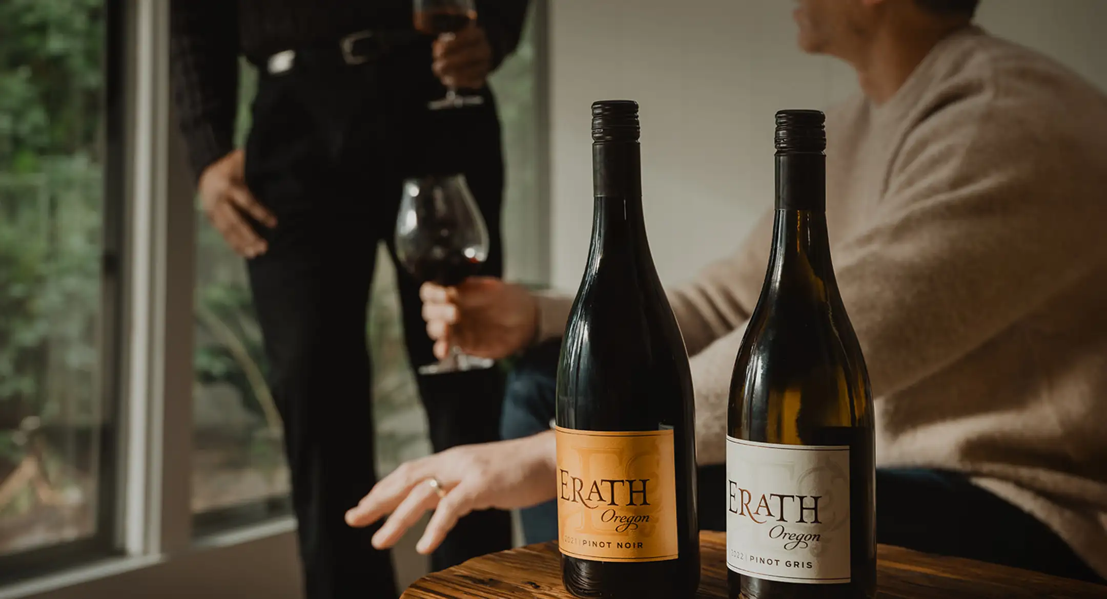 Two people socializing while drinking Erath wines.