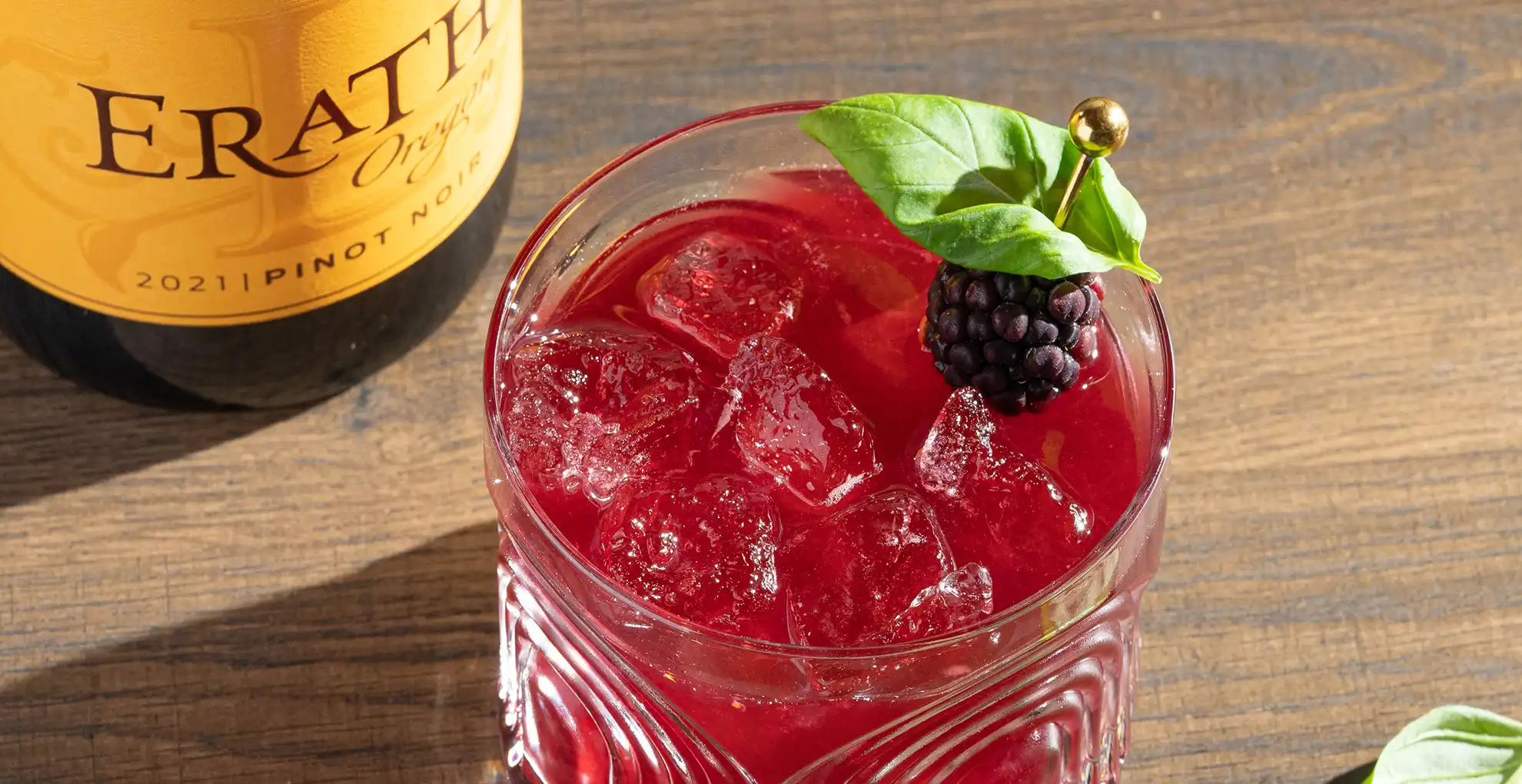glass of Pinot Blackberry Basil Smash with erath oregon pinot noir bottle