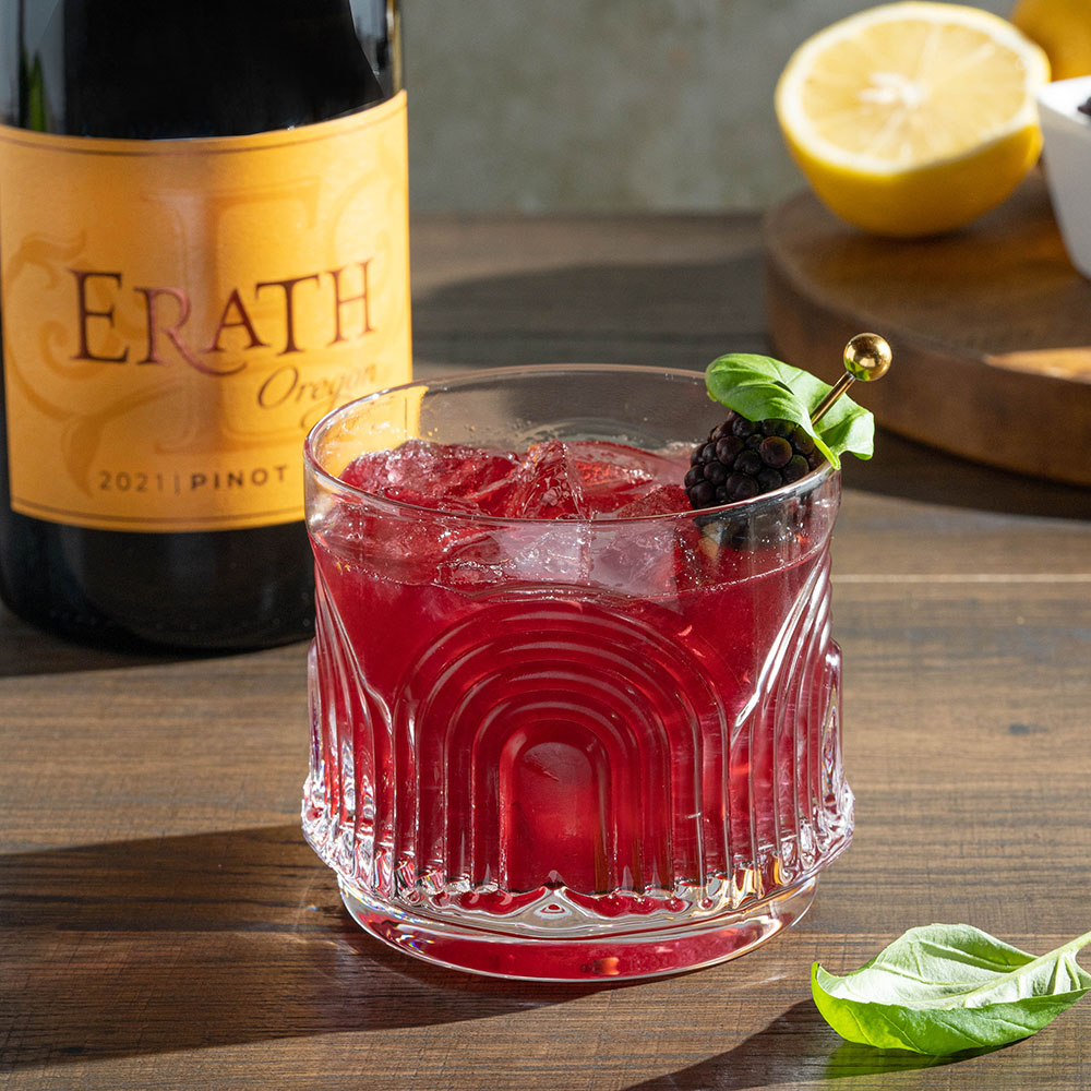 glass of Pinot Blackberry Basil Smash with erath oregon pinot noir bottle