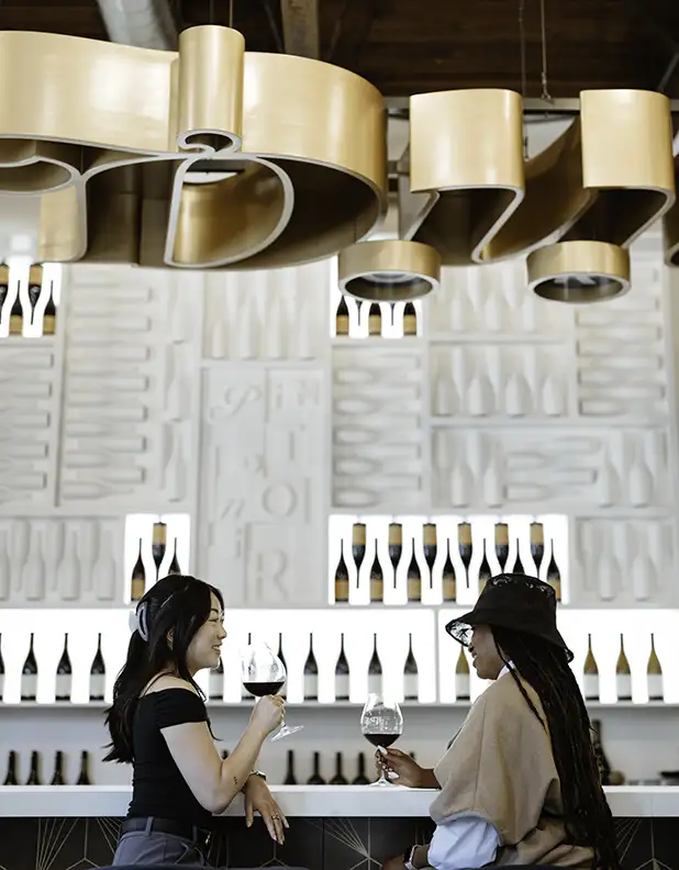 Two people enjoying wine in the Erath tasting room.