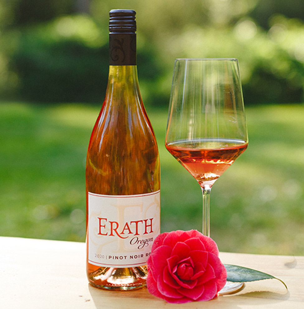 erath rose on table with a glass and flower