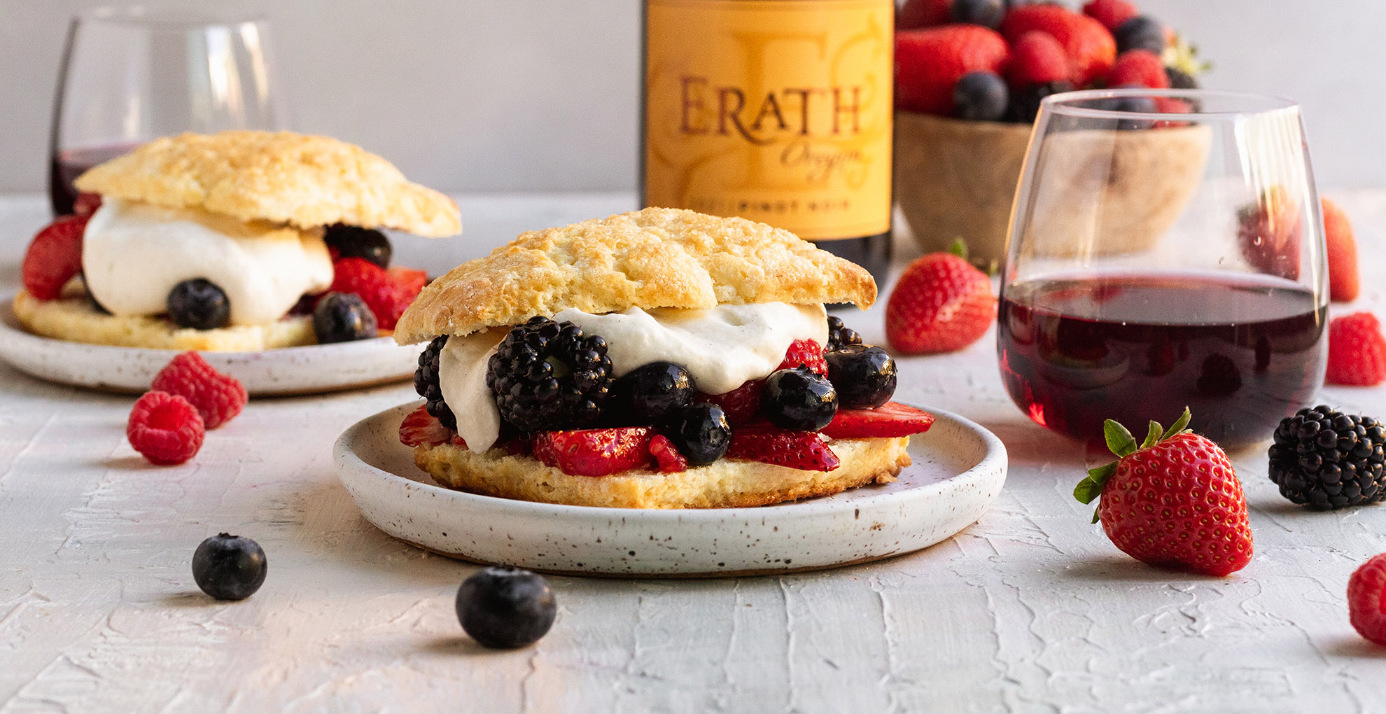 berry shortcakes on plates with a glass and bottle of erath oregon pinot noir