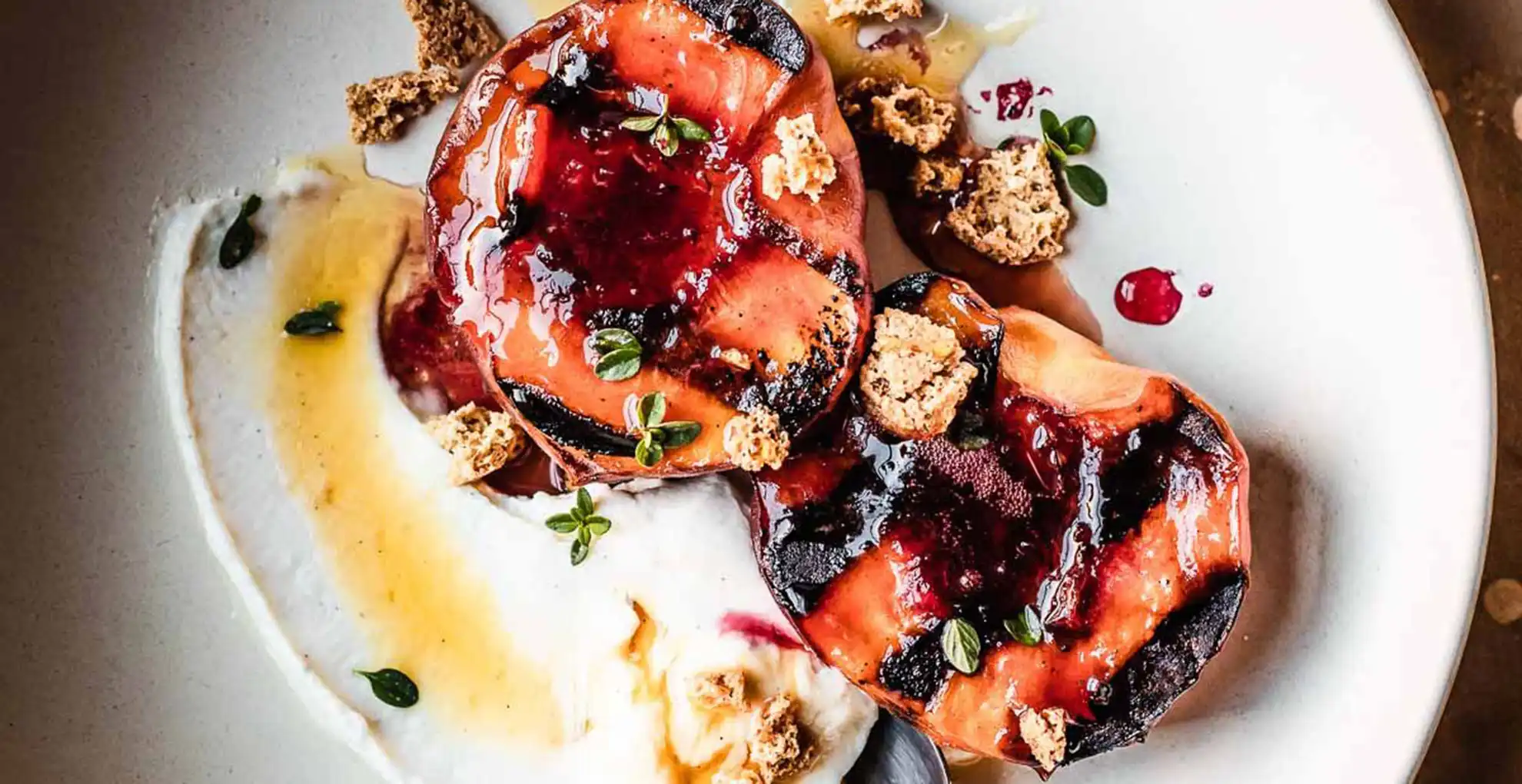 grilled peaches with mascarpone on a plate
