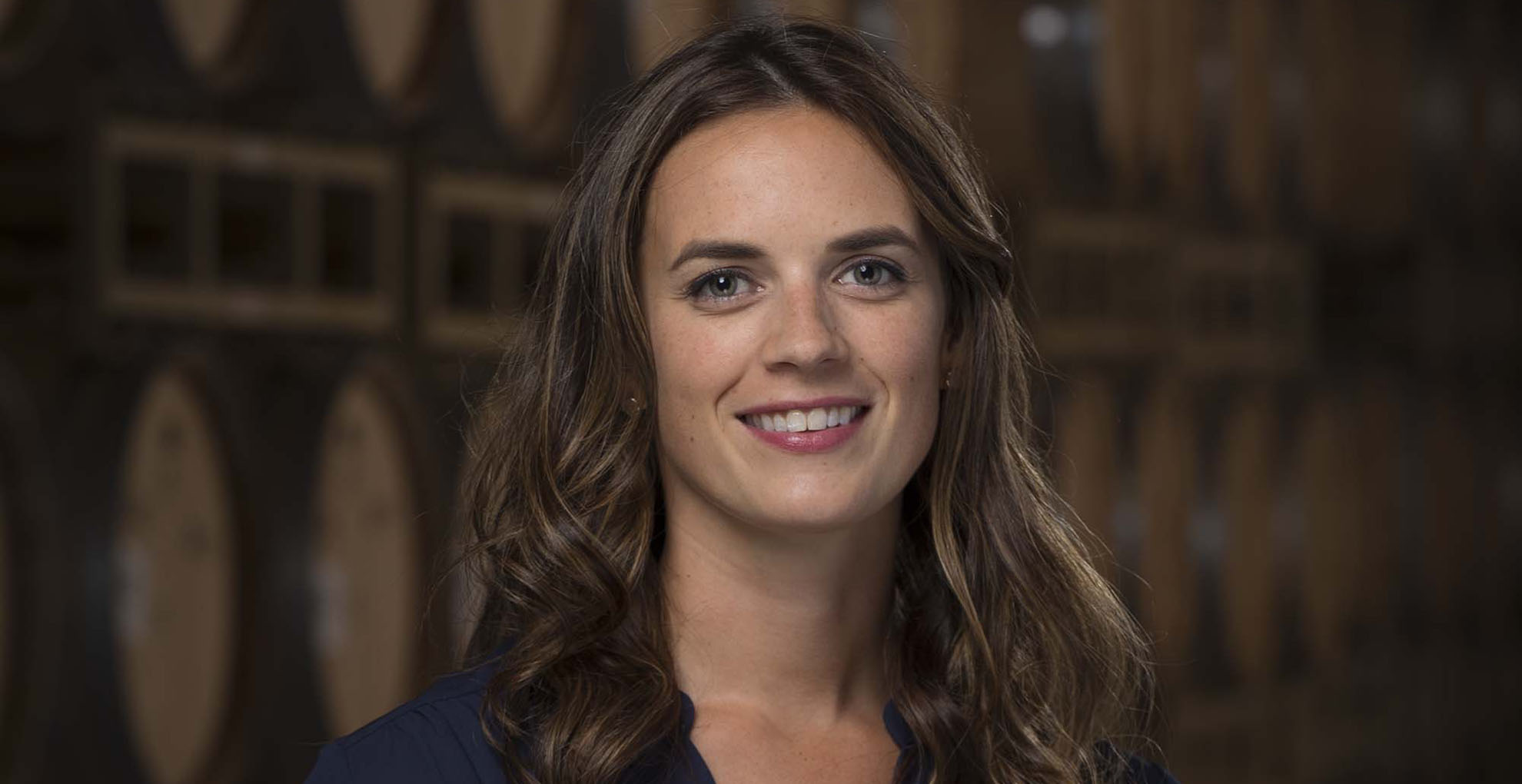 head winemaker leah smiling in barrel room