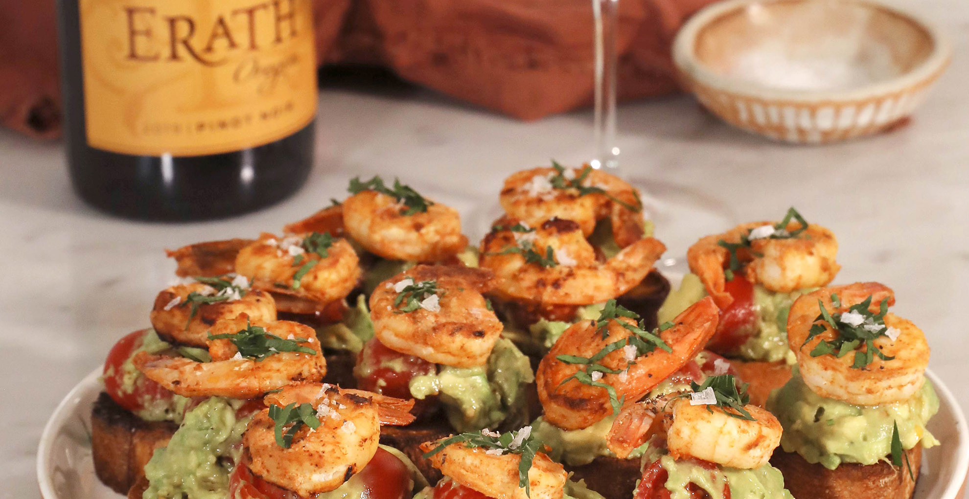 spicy shrimp crostini on plate with erath oregon pinot noir