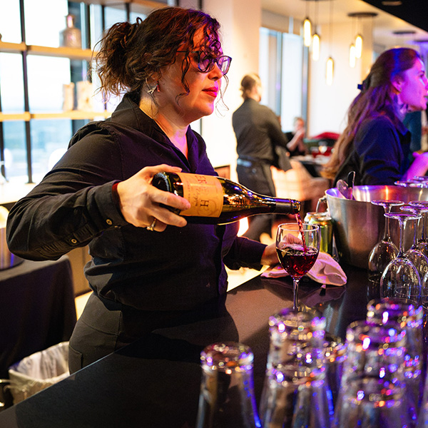 woman pouring erath pinot noir at portland light festival