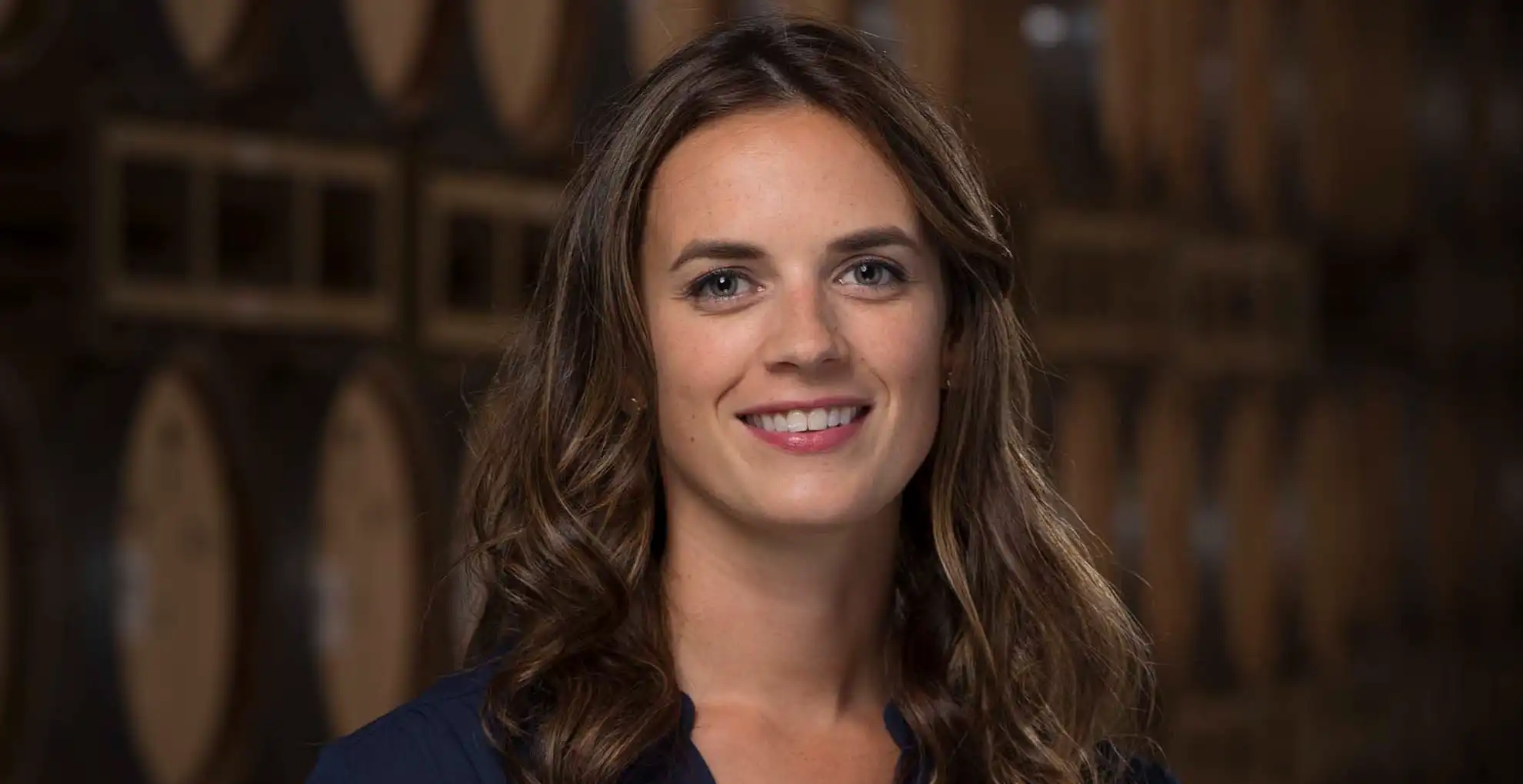 head winemaker leah smiling in barrel room