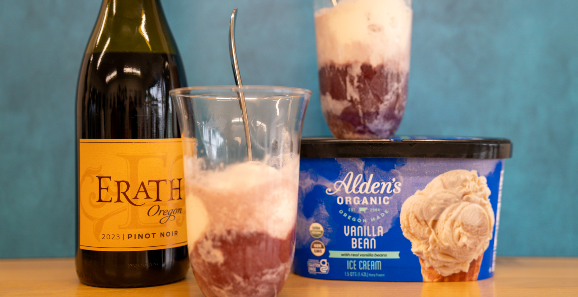 A bottle of Erath Oregon Pinot Noir sits beside a container of Alden's Vanilla Bean Ice Cream. A glass containing a pinot float sits on top of the ice cream