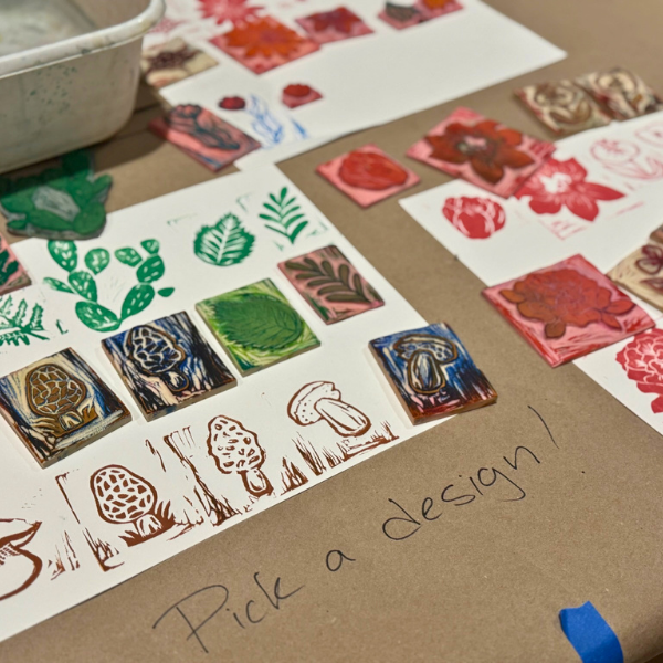 Sample stamp options for a craft are displayed on a table