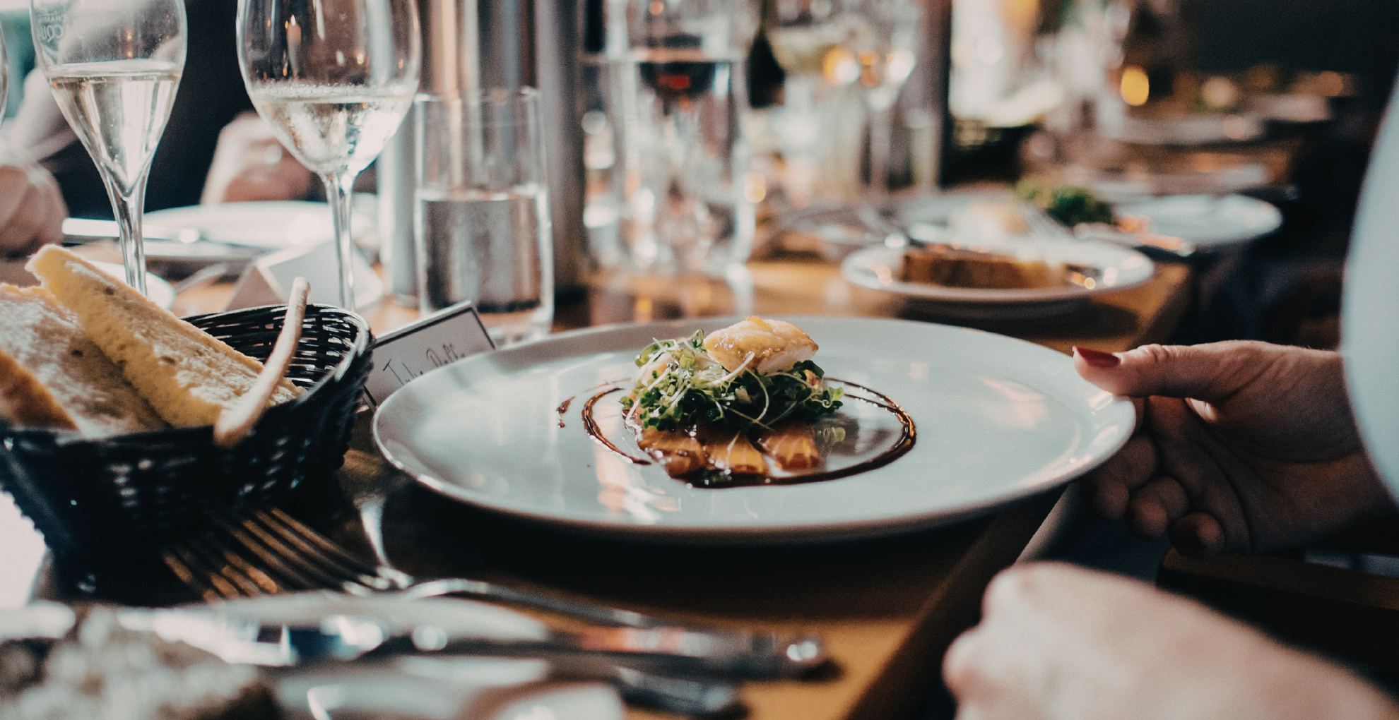 A gourmet plate of food sits on a dinner table.